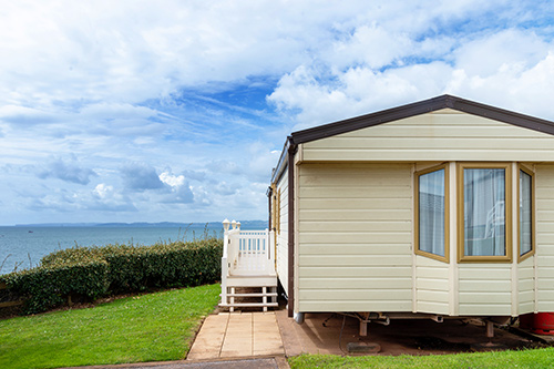 static caravan with a view of blue skies and the sea in the backgroun
